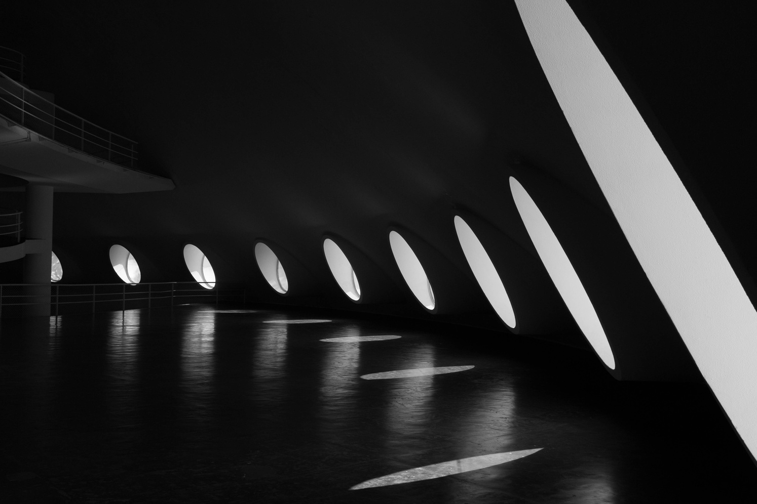 Black and White Photography Of Building With Round Windows